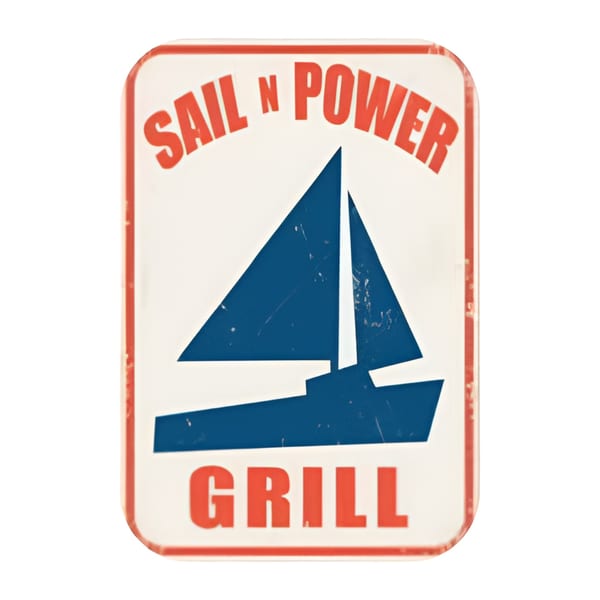 Sail N' Power Grill sign with a blue sailboat graphic on a white background with red trim.