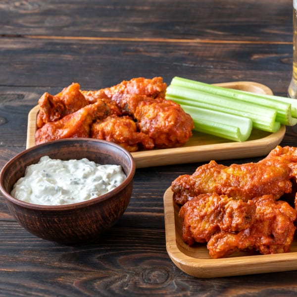 Sail N' Power Grill's buffalo wings with celery sticks and a bowl of ranch dressing.
